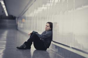 Young Sad Woman In Pain Alone And Depressed At Urban Subway Tunn